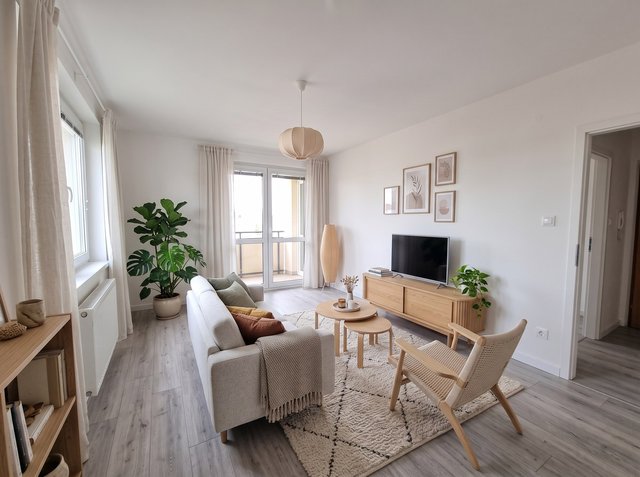 Attempt 2: the same room staged with a sofa, a rope lounge chair, an oak TV unit and a bookcase, but the round flush ceiling light has been replaced by a paper pendant shade