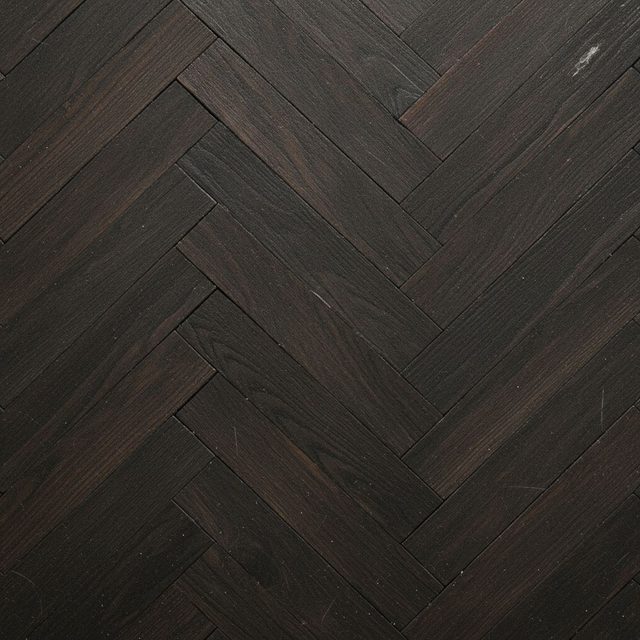 Flooring sample: dark smoked oak laid in a herringbone pattern
